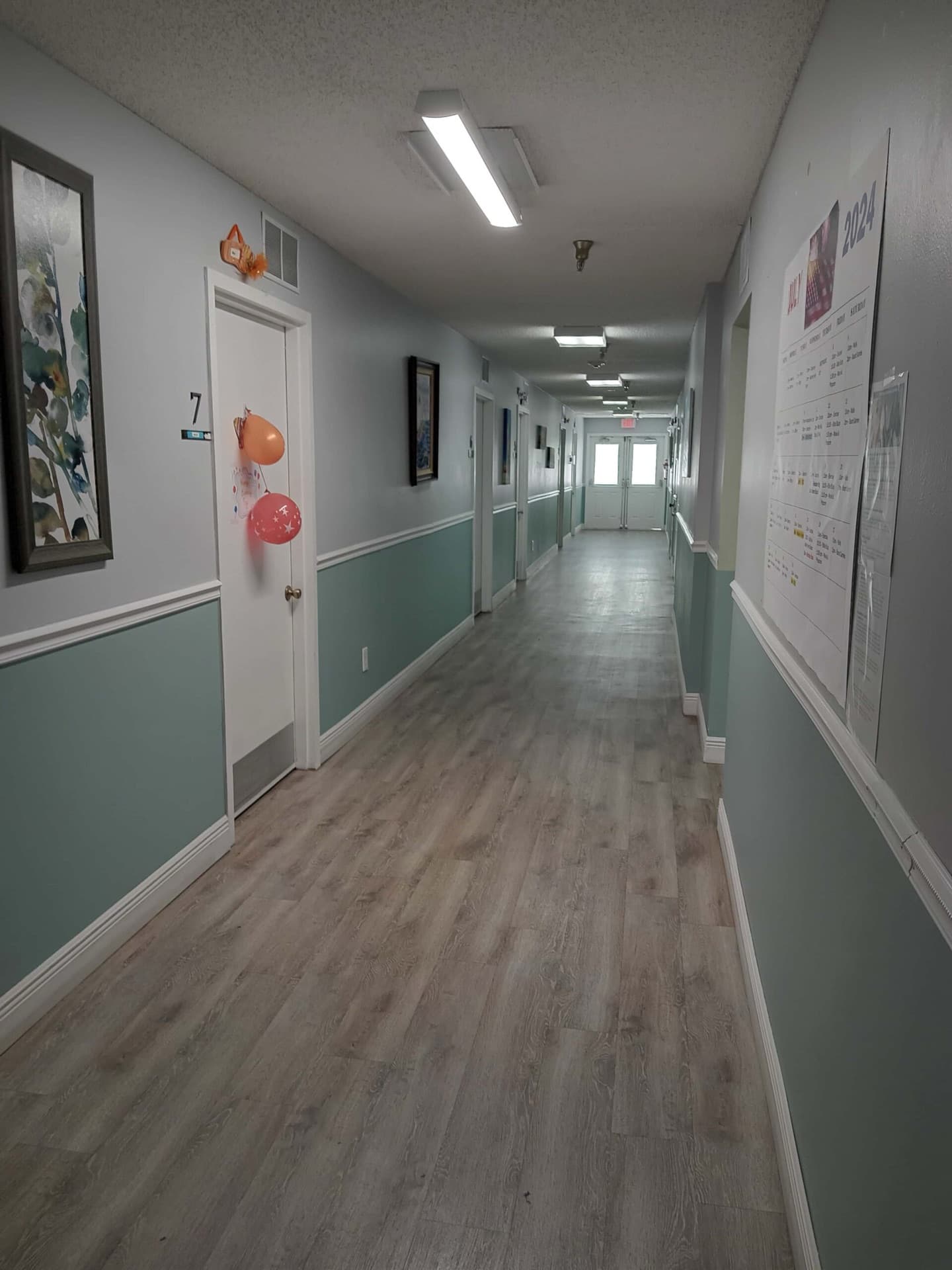 Bright resident room hallway at Sugarmill Manor